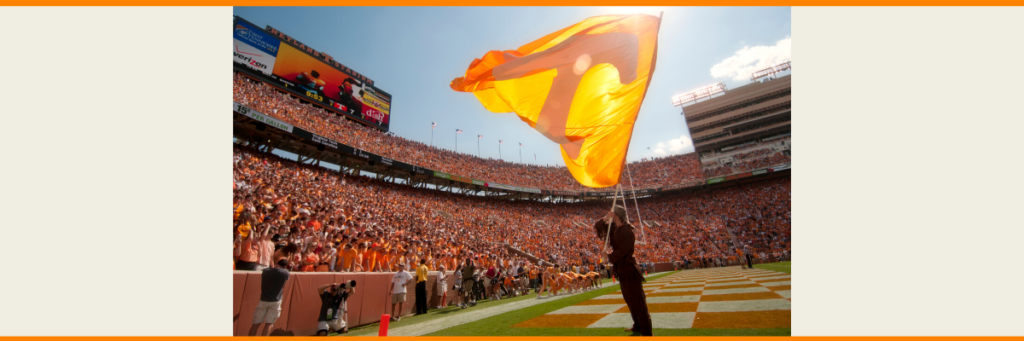 A picture of Davy Crockett waving the power T flag inside of Neyland stadium on game day.